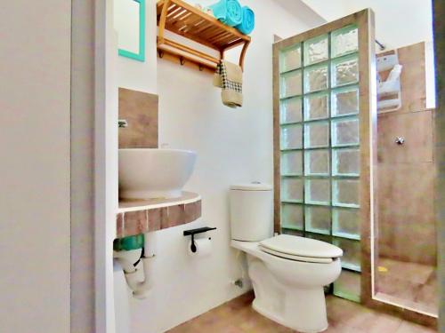 a bathroom with a toilet and a sink at Casa Brisamar , Studios in Puerto Morelos