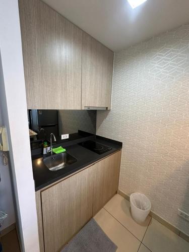 a small kitchen with a sink and a counter at unixx seaview in Pattaya South