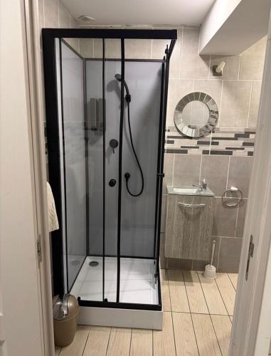 a shower with a glass door in a bathroom at Cosy Room Trèbes in Trèbes