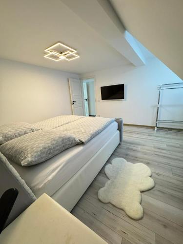 a bedroom with a bed and a white rug at Apartament Bors in Ribnitz-Damgarten