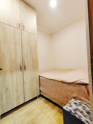 ein Zimmer mit Holzschränken und einem Bett darin in der Unterkunft Jermuk Mini Apartment in Dschermuk