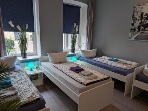 a room with two beds and a couch in it at Stadtnah an der Förde 75 in Flensburg