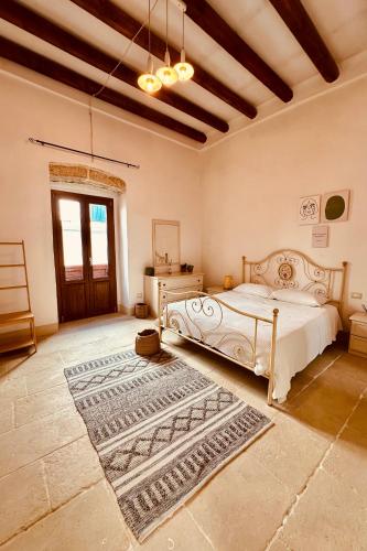 a bedroom with a bed and a rug at Corte San Giorgio in Matino