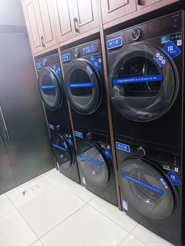 a group of four washing machines in a room at Nostalgia Hotel Beijing Yonghe Lama Temple in Beijing