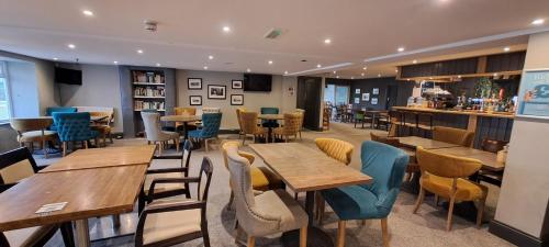 a restaurant with wooden tables and chairs at Blue Lagoon Holiday ,Bude 79 in Cubert