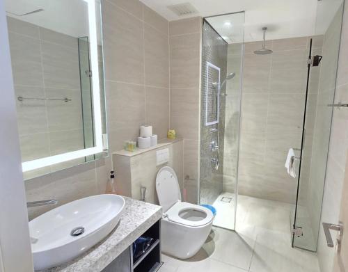 a bathroom with a toilet and a sink and a shower at Star Infinity Pool At Klcc in Kuala Lumpur