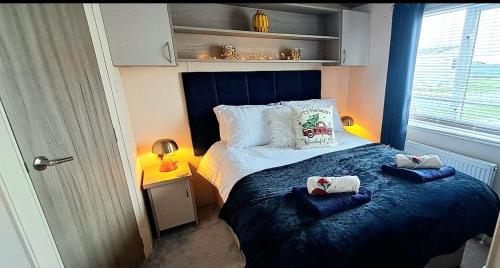 a bedroom with a bed with two towels on it at Blue Lagoon Holiday ,Bude 79 in Cubert
