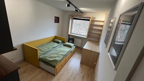 a small bedroom with a bed and a window at REMI Apartament Biotura in Gdańsk