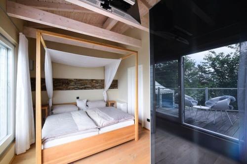 a bedroom with a bed and a balcony at Erfurt Haus Paradies in Erfurt
