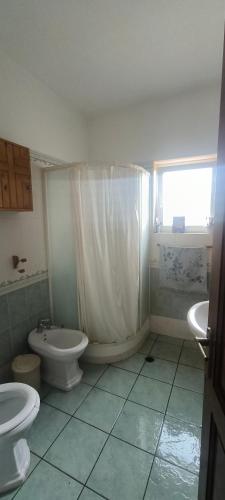 a bathroom with a toilet and a tub and a sink at Kounis Villa in Chalkida