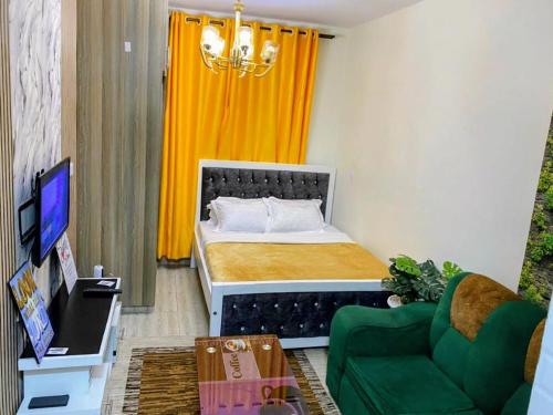 a small bedroom with a bed and a couch at Gnittel haven in Nairobi