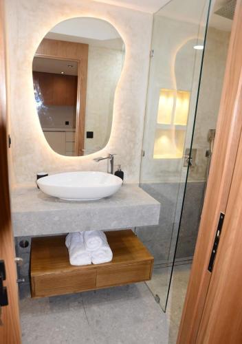 a bathroom with a sink and a mirror at duplex bord de mer résidence restinga smir in Restinga Smir