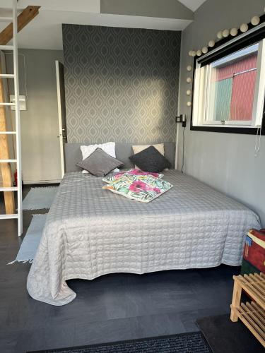 a bedroom with a large bed with a white comforter at Stuga nära havet in Ystad