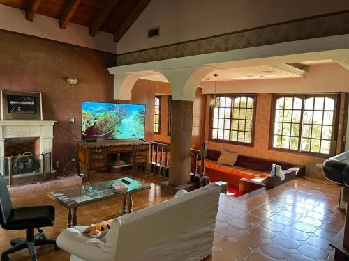 a living room with a couch and a tv at SWEET HOME PATAGONIA in Comodoro Rivadavia