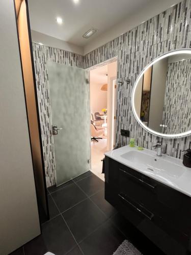 a bathroom with a sink and a mirror at Buganvilla Garden Puerto de la Cruz in Puerto de la Cruz