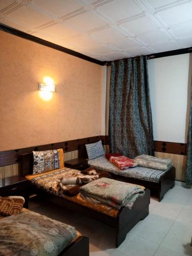 a person laying on a bed in a room at Mount heaven Hotel in Murree