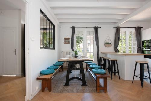 una sala da pranzo con un tavolo con sedie imbottite blu di Maison design a Tolosa