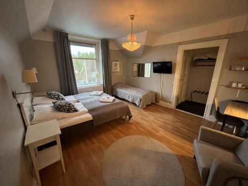 a living room with a couch and a bed at Hotell Strandvillan Orsa in Orsa