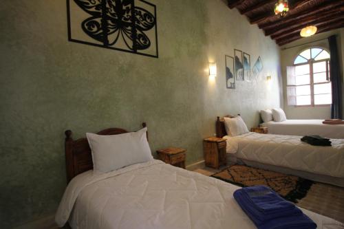 Ένα ή περισσότερα κρεβάτια σε δωμάτιο στο Dar Aicha