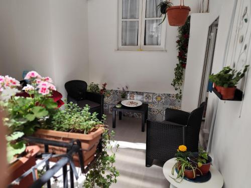 a balcony with potted plants and a table at Opera Prima 28 in Palermo