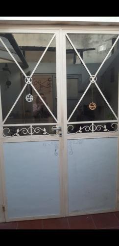 a pair of glass doors with metal railing at Casa cómoda familiar in La Plata