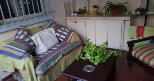 a living room with a couch and a table at Casa cómoda familiar in La Plata