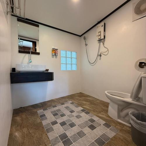 a bathroom with a sink and a toilet at Mangrove bungalow & restaurant in Ko Kood