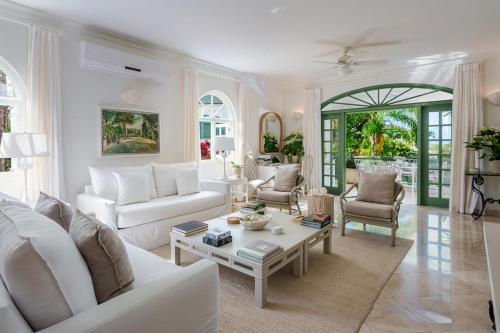 een woonkamer met witte meubels en een tafel bij Sugar Hill - Jade Vine 3 bed villa in Saint James