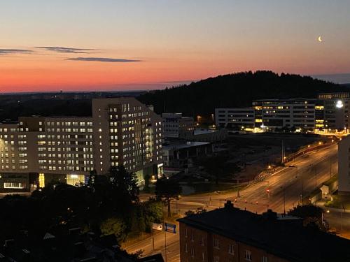 a city at night with the moon in the sky at Wesfield Private in Solna
