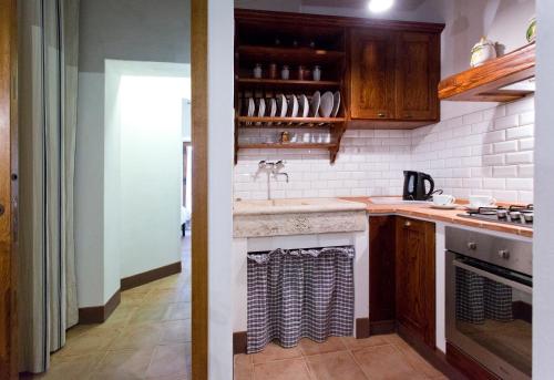 a kitchen with a sink and a counter top at Casa vacanza vicolo degli orti in Monticiano