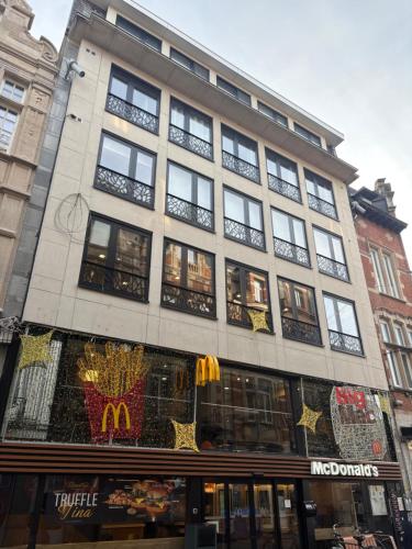 a large building with windows on a street at Briefstreet - Louvain in Leuven