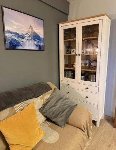 a living room with a cabinet and a couch at Anayet Sweet Home in Formigal