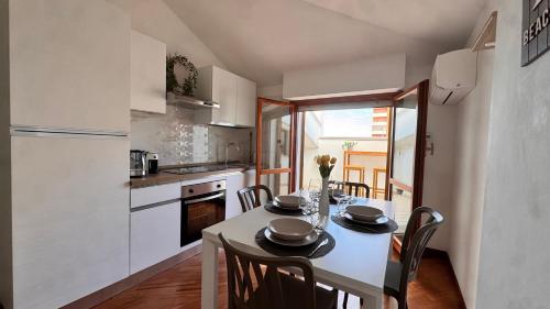 a kitchen with a table and chairs in a kitchen at Gioia's House in Montesilvano