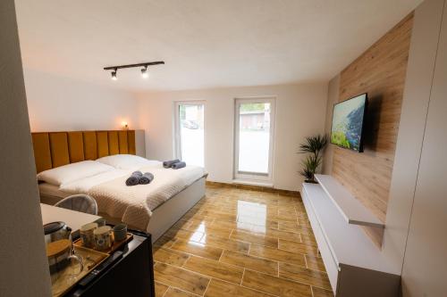 a hotel room with a bed and a kitchen at Apartmány Slanica in Námestovo