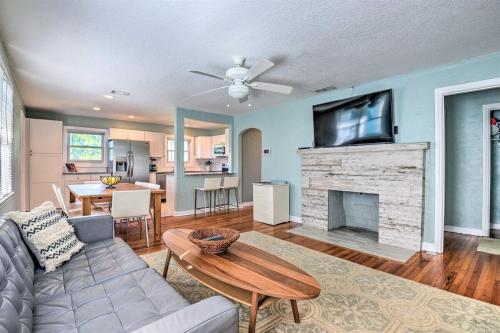a living room with a couch and a tv over a fireplace at Updated Home Steps to Daytona Beach in Daytona Beach