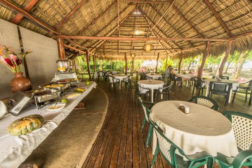 a dining room with tables and chairs and tablesearcher at Karahe Beach Hotel in Manuel Antonio
