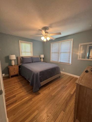 a bedroom with a bed and a ceiling fan at Updated Home Steps to Daytona Beach in Daytona Beach