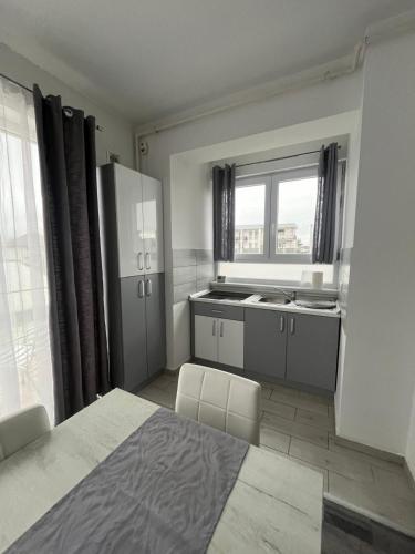 a small kitchen with a refrigerator and a window at db Home - Near Brasov City Center in Ghimbav