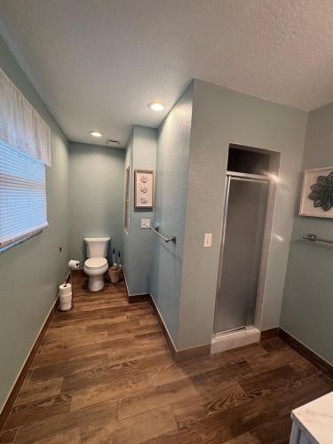 a bathroom with a toilet and a shower stall at Updated Home Steps to Daytona Beach in Daytona Beach