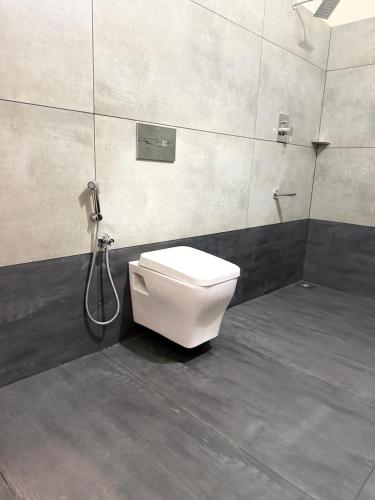 a bathroom with a toilet and a shower at Casa Linda Residency in Varkala