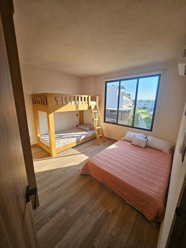 a bedroom with two bunk beds and a window at DAGA House Pool table, pool and air conditioning in Alpuyeca
