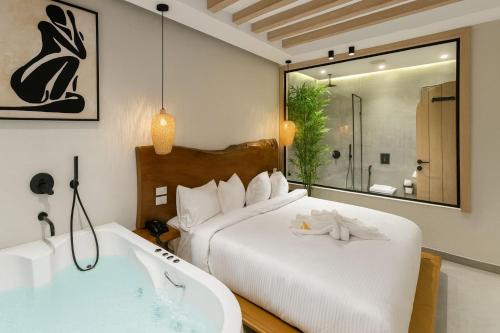 1 dormitorio con bañera, 1 cama y bañera en ONE GATE Pyramids View INN, en El Cairo