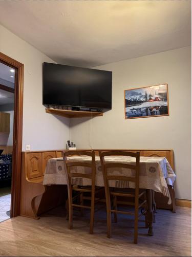 a living room with a table and a flat screen tv at Anayet Sweet Home in Formigal