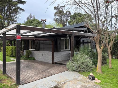 a house with awning on the front of it at Casa estilo cabaña a 3 cuadras del mar in Mar del Plata