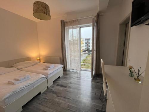 a bedroom with a bed and a large window at db Home - Near Brasov City Center in Ghimbav