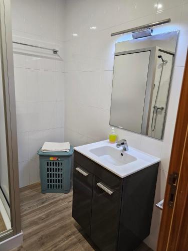 a bathroom with a sink and a mirror at Casa Trevo de 4 Folhas in Furnas
