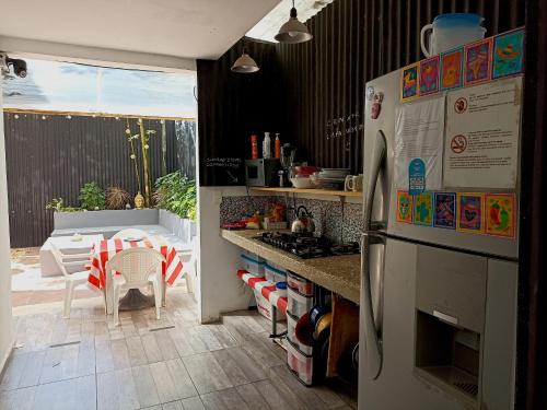 a kitchen with a refrigerator and a table and a patio at TR3S by Walter de la Renta in Cancún