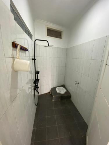 a small bathroom with a toilet in a stall at Villa Pangalengan in Palayangan