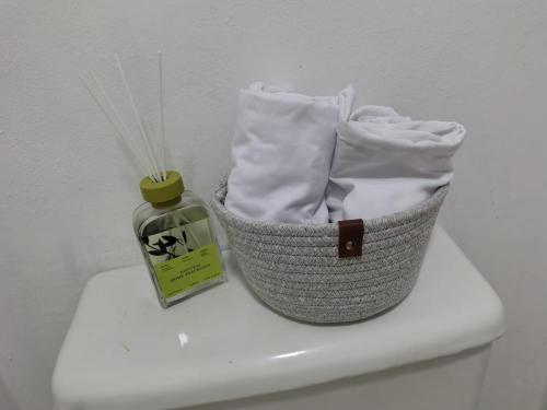 a basket on top of a toilet with a bottle of soap at La Guarida de Mela in Santo Domingo