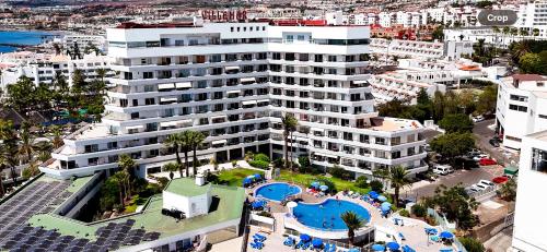 an aerial view of a large white building with a pool at Club Villamar Exclusive Beachfront Penthouse in Adeje